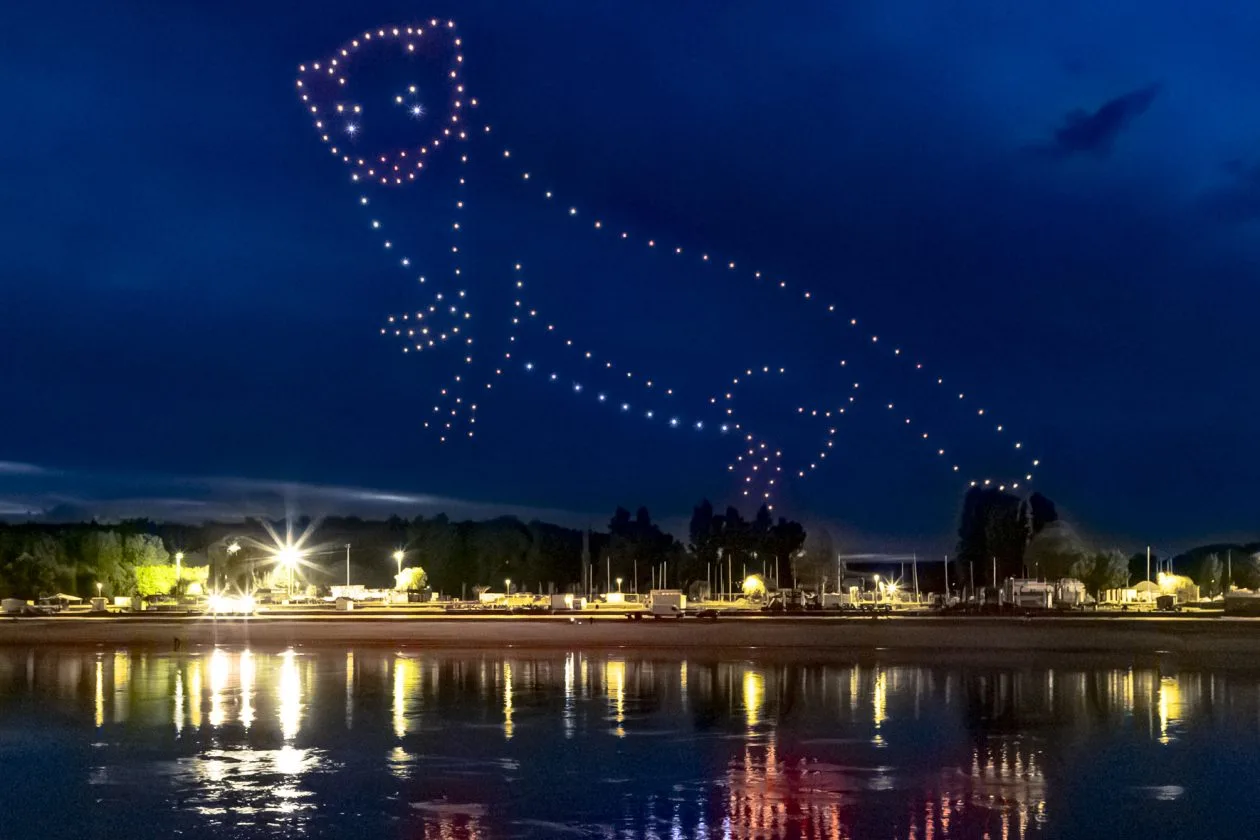 Drone marten figure glowing above the water