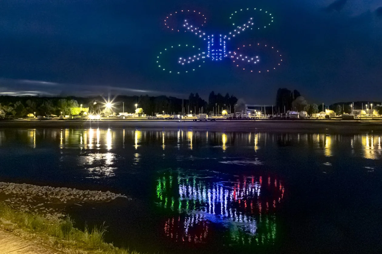 Giant drone-formed quadcopter reflected over the waterfront