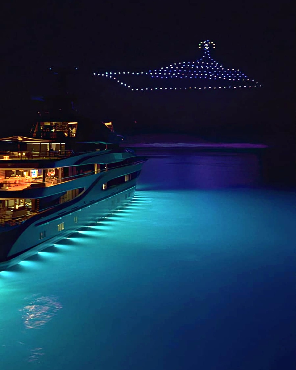 Drone silhouette of a yacht glowing above the vessel